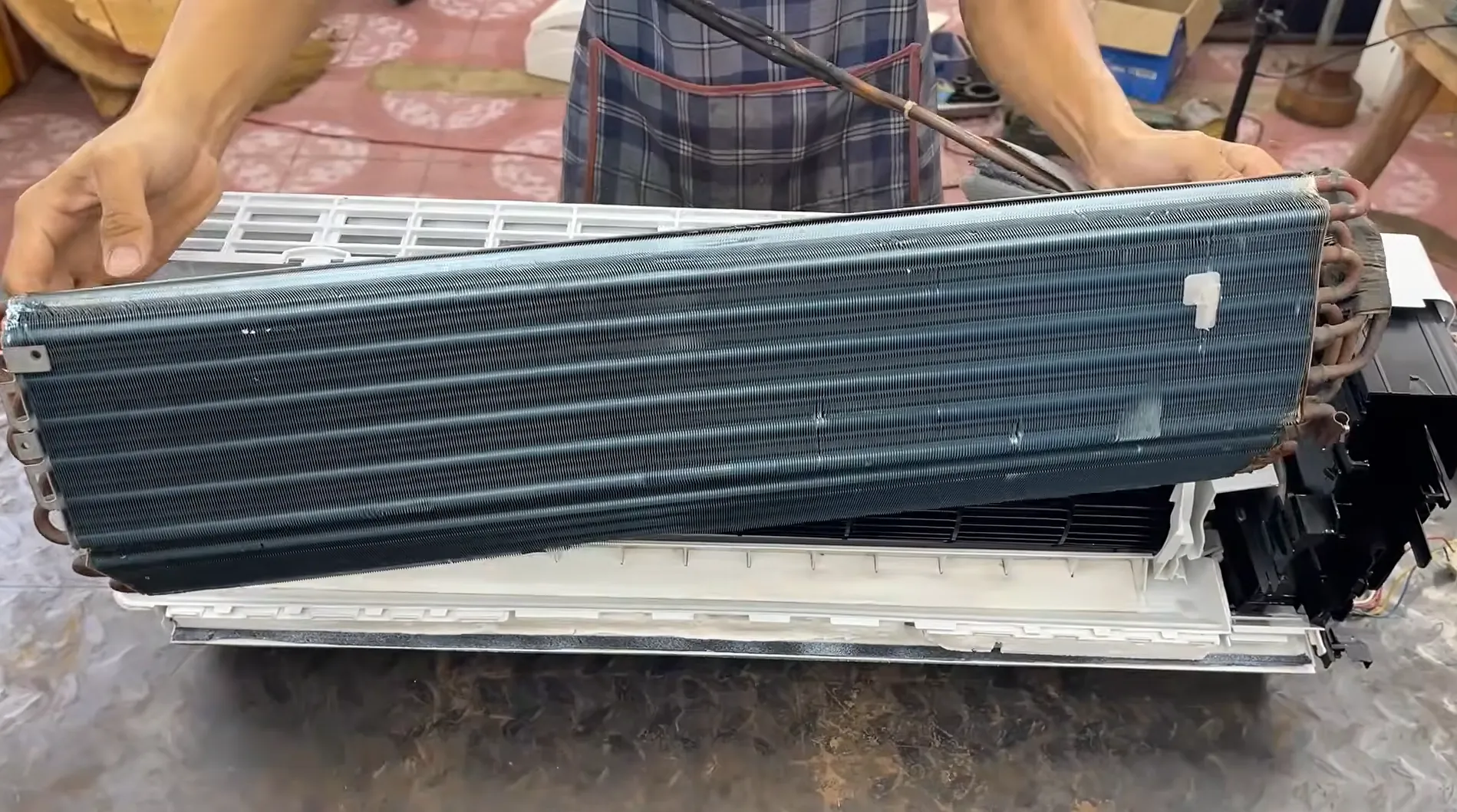 Expert technician carrying out aircond installation in a Kuala Lumpur home